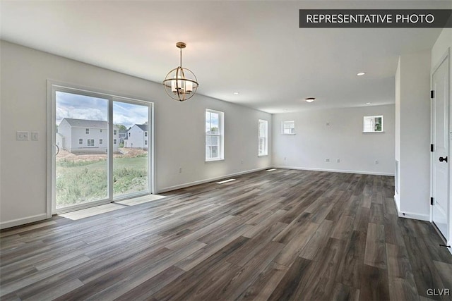 interior space with dark wood-type flooring and a chandelier