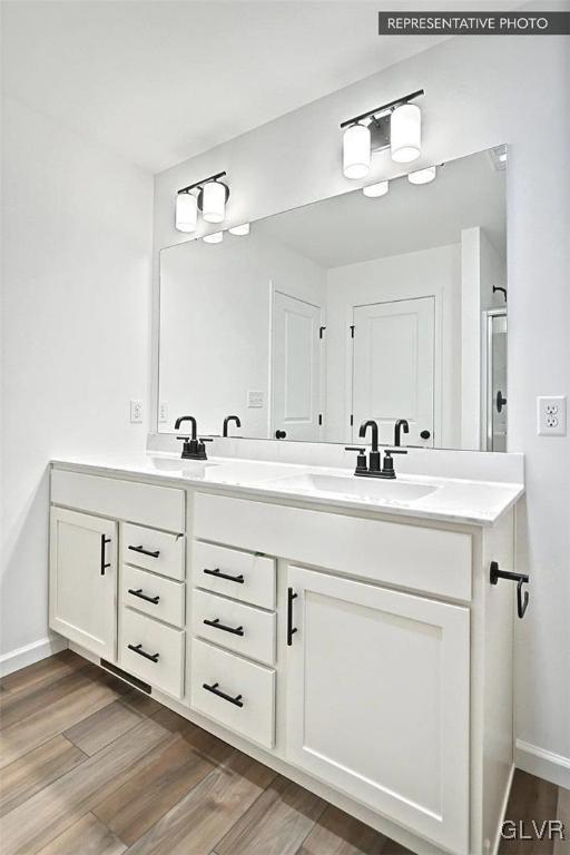 bathroom featuring vanity and wood-type flooring