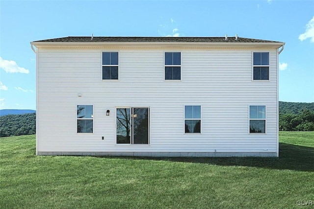 rear view of house with a yard