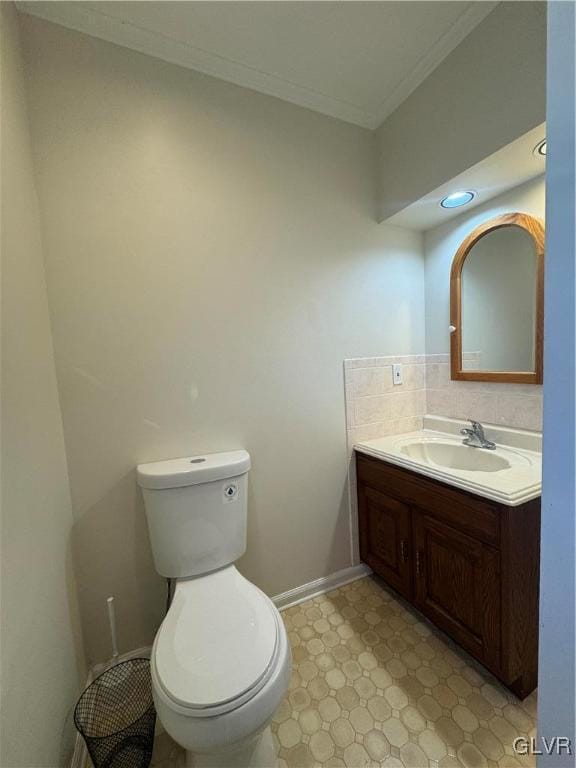 bathroom featuring crown molding, vanity, and toilet