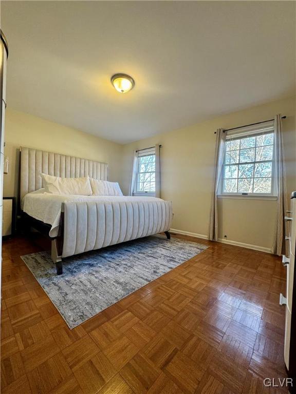 bedroom with dark parquet flooring