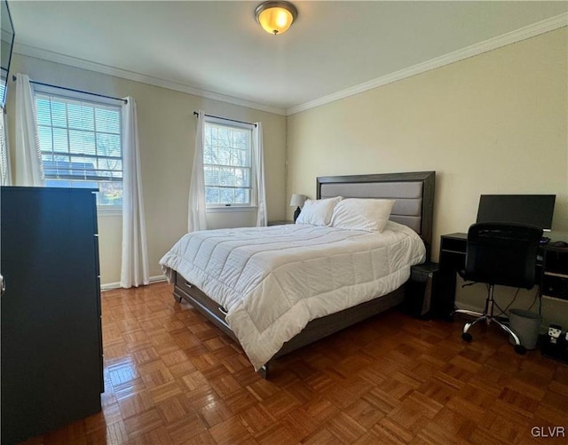 bedroom with crown molding and dark parquet flooring