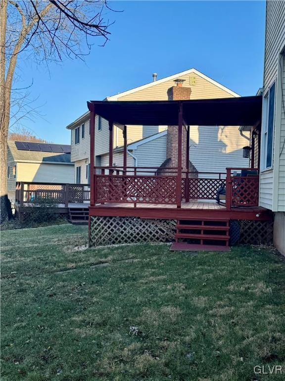 view of home's exterior with a yard and a deck