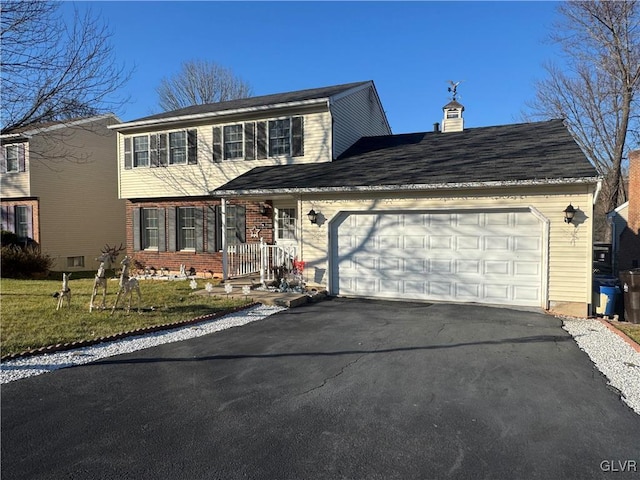 front facade featuring a garage and a front lawn