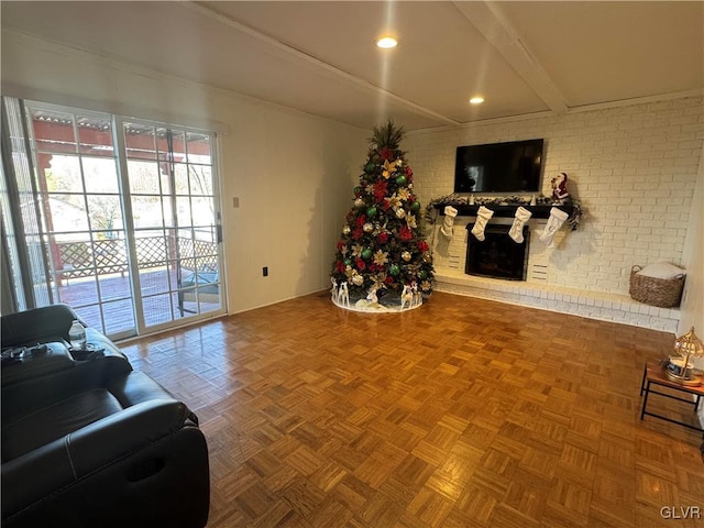 living room with parquet flooring, brick wall, a fireplace, and beam ceiling