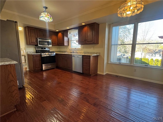 kitchen featuring crown molding, stainless steel appliances, dark hardwood / wood-style flooring, and hanging light fixtures