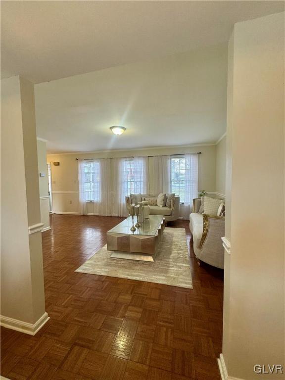 living room featuring dark parquet floors