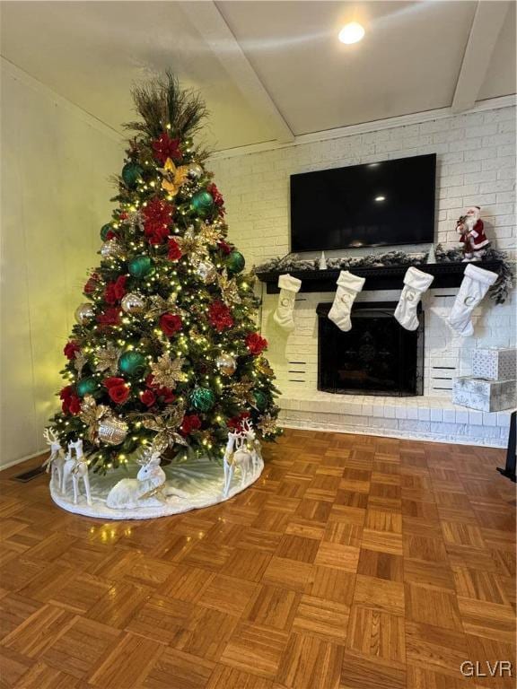 room details featuring parquet flooring and a brick fireplace