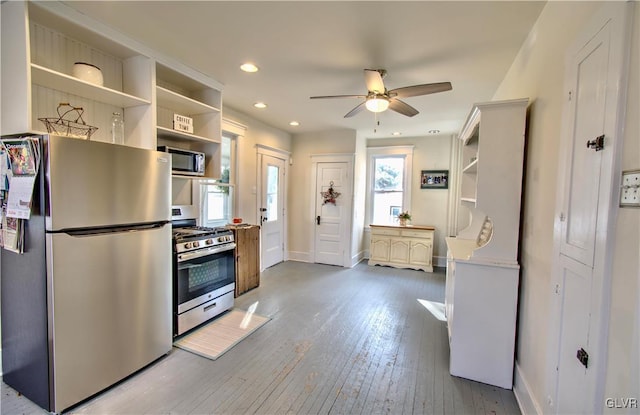 kitchen featuring stainless steel appliances, light hardwood / wood-style flooring, and ceiling fan