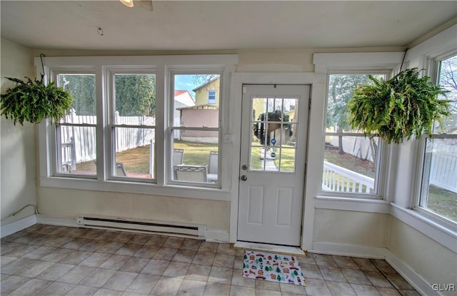 doorway with a wealth of natural light and a baseboard radiator