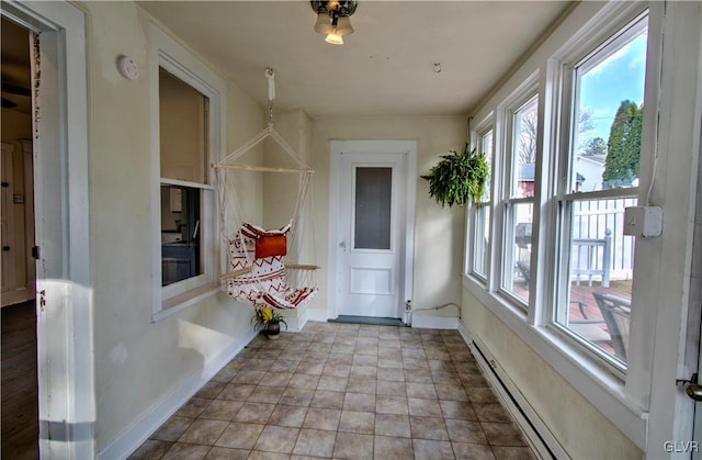 unfurnished sunroom with a baseboard heating unit