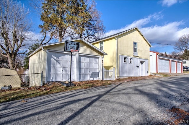 view of side of home featuring an outbuilding and a garage