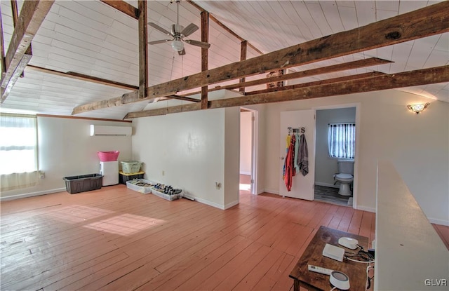 812 Lehigh St, Jim Thorpe Borough, PA 18229 - unfurnished living room featuring a wall unit AC, hardwood / wood-style flooring, and a ceiling fan