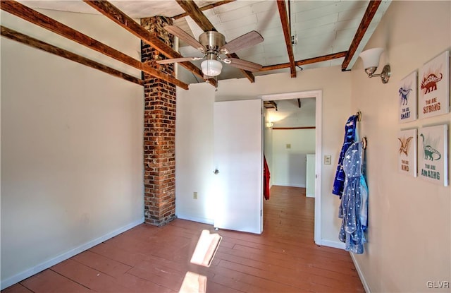 unfurnished bedroom with beam ceiling, ceiling fan, and hardwood / wood-style flooring