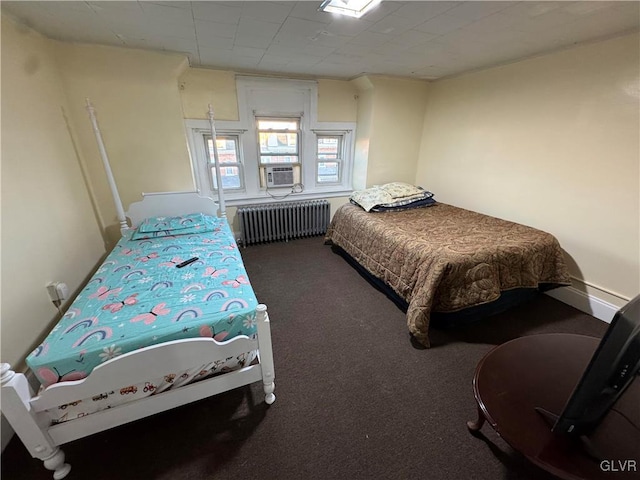 bedroom with radiator, cooling unit, and dark colored carpet