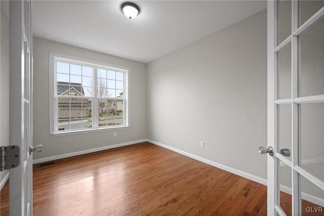 empty room featuring wood-type flooring