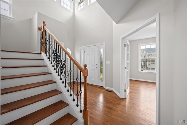 entryway with a high ceiling and light wood-type flooring