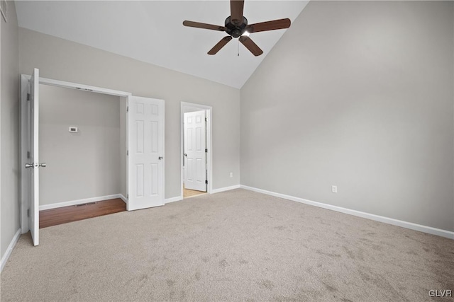 unfurnished bedroom with ceiling fan, carpet floors, and high vaulted ceiling