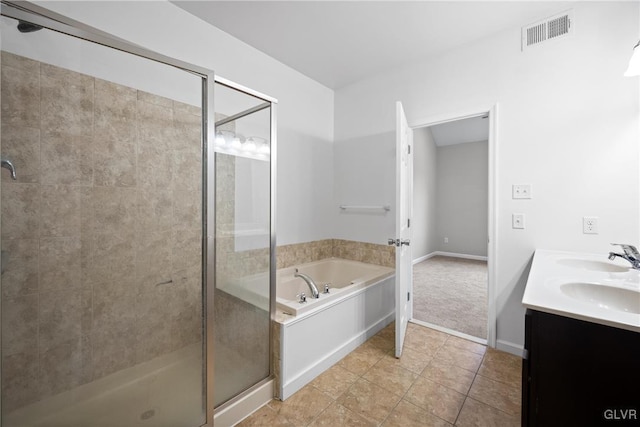 bathroom with tile patterned flooring, vanity, and shower with separate bathtub