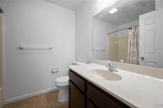 bathroom with tile patterned flooring, vanity, toilet, and walk in shower