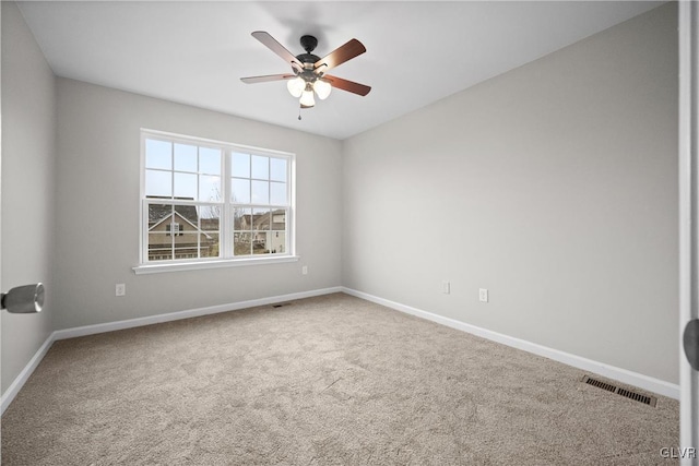 carpeted spare room featuring ceiling fan