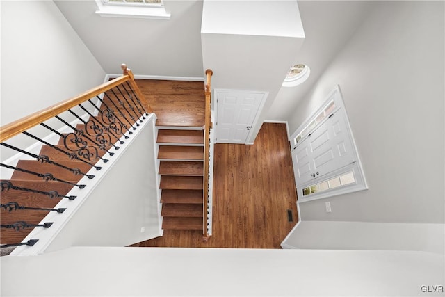 stairway featuring wood-type flooring