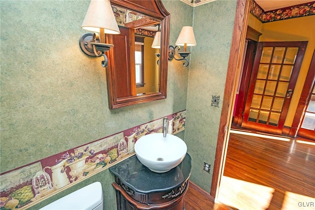 bathroom featuring hardwood / wood-style floors, vanity, and toilet