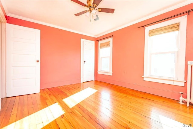 spare room with ceiling fan, wood-type flooring, and crown molding