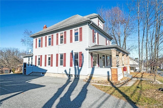 view of side of property featuring a porch