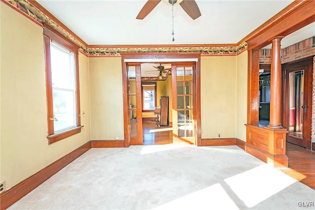 spare room with hardwood / wood-style flooring, a healthy amount of sunlight, and ornate columns