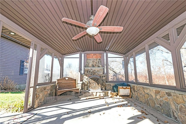 unfurnished sunroom with ceiling fan, wooden ceiling, and vaulted ceiling