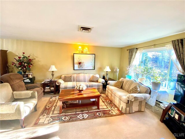 living room featuring carpet floors and an inviting chandelier