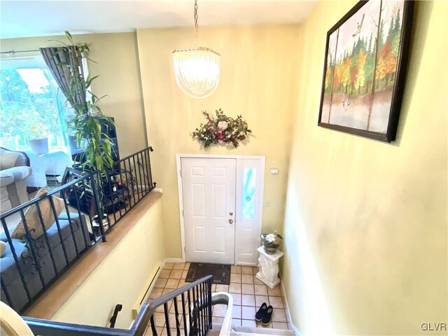 foyer featuring tile patterned flooring and a chandelier