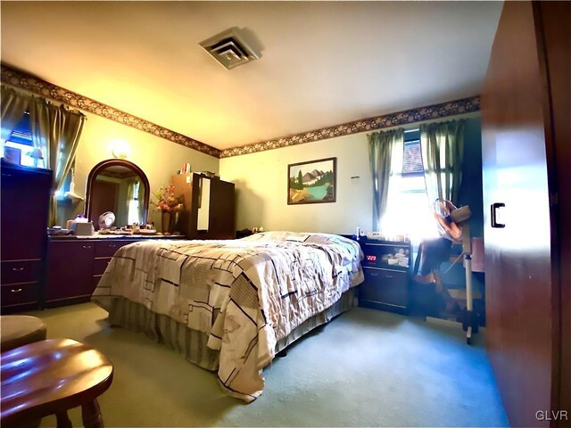 bedroom featuring light colored carpet