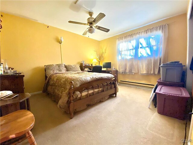 carpeted bedroom featuring baseboard heating and ceiling fan