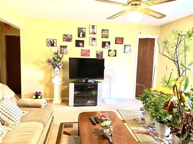 living room with ceiling fan and carpet floors