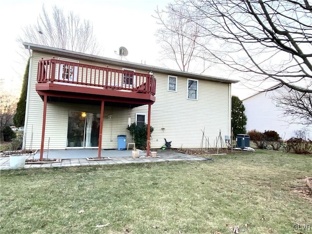 back of house with a patio area, a yard, a wooden deck, and central AC