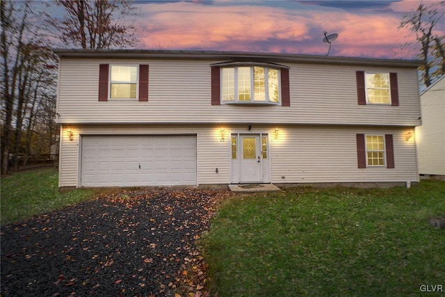 view of front of property with a yard and a garage