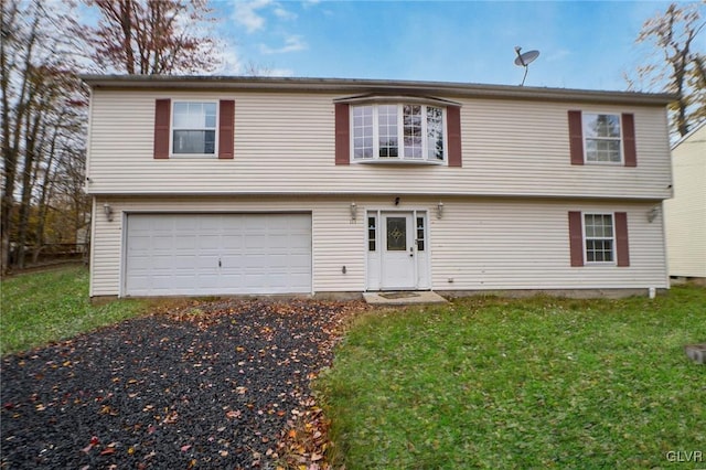 view of front of home with a front yard and a garage