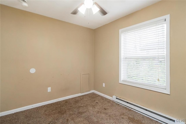 spare room with ceiling fan, carpet floors, and a baseboard heating unit