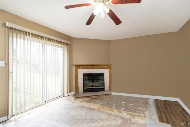 unfurnished living room with a wealth of natural light, a fireplace, and ceiling fan