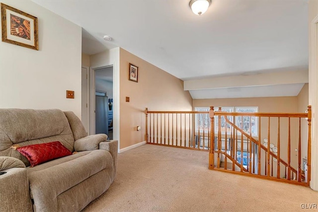 sitting room with carpet floors and lofted ceiling