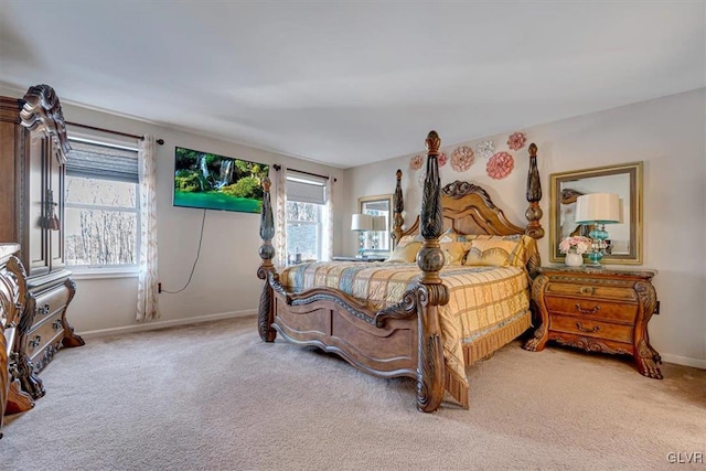 bedroom with light carpet and multiple windows