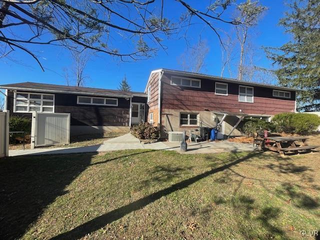 rear view of house with a yard