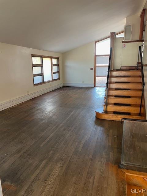 unfurnished living room with dark wood-type flooring and lofted ceiling