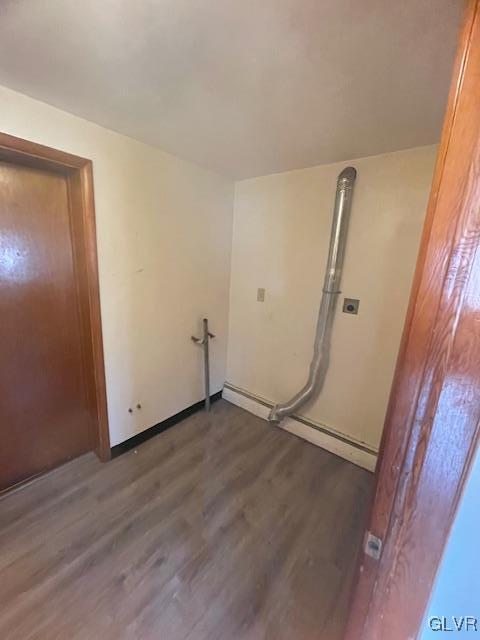 clothes washing area featuring dark hardwood / wood-style flooring