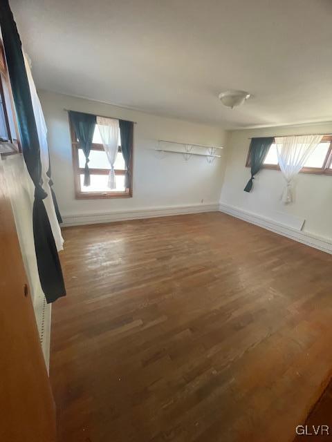 additional living space featuring dark wood-type flooring