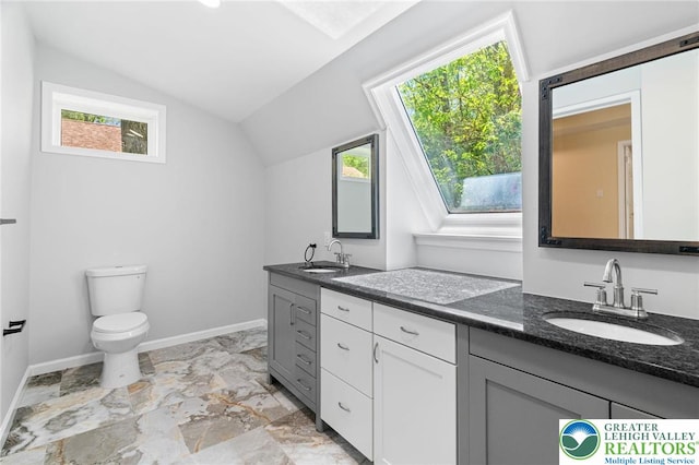 410 Sunset Forest Dr, Pike, PA 18428 - bathroom with vaulted ceiling, healthy amount of natural light, toilet, vanity, and baseboards