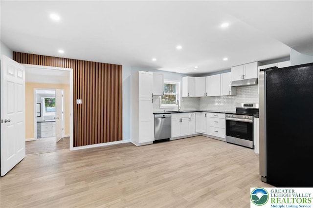 410 Sunset Forest Dr, Pike, PA 18428 - kitchen with appliances with stainless steel finishes, a sink, under cabinet range hood, backsplash, and healthy amount of natural light