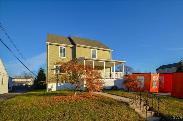 view of front of house with a porch and a front lawn